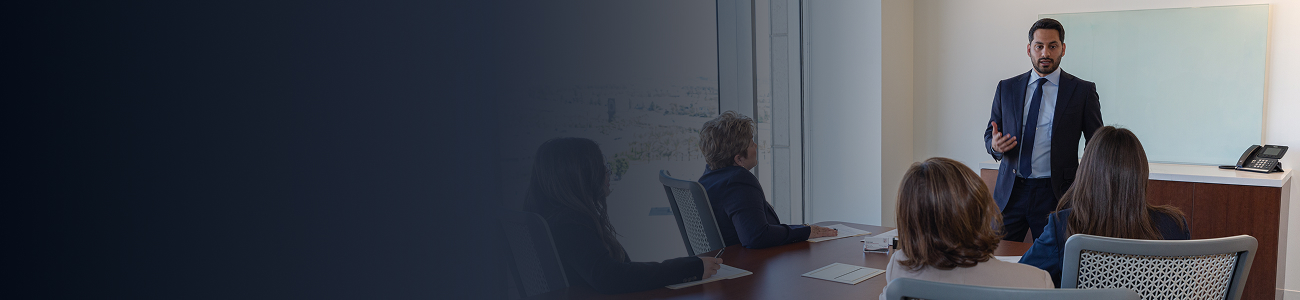 Business professional presenting to colleagues in a conference room